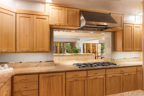 a kitchen with stainless steel appliances granite countertop a sink and cabinets