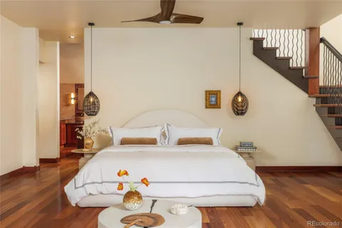 a bedroom with a bed and a potted plant