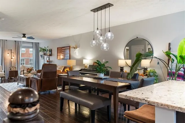 a living room with furniture a chandelier and a dining table