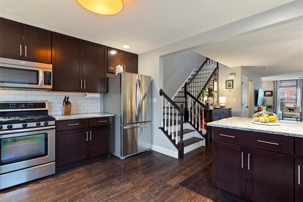 1507 Federal Street Pittsburgh, PA 15212 - Photo 15 of 45 a kitchen with refrigerator and wooden floor