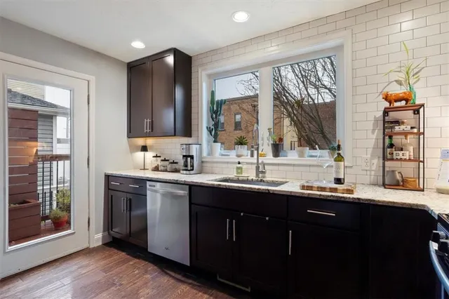 a kitchen with a sink and wooden cabinets