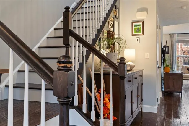 a view of entryway with wooden floor and stairs