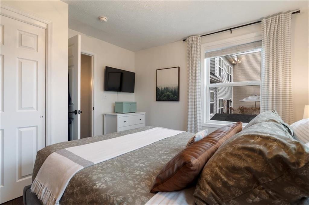 1507 Federal Street Pittsburgh, PA 15212 - Photo 22 of 45 a bedroom with a large bed and a flat tv screen