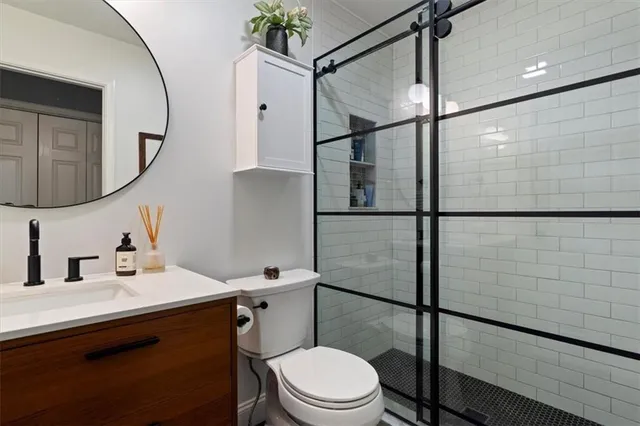a bathroom with a sink toilet and shower