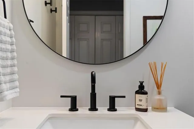 a bathroom with a sink and a mirror