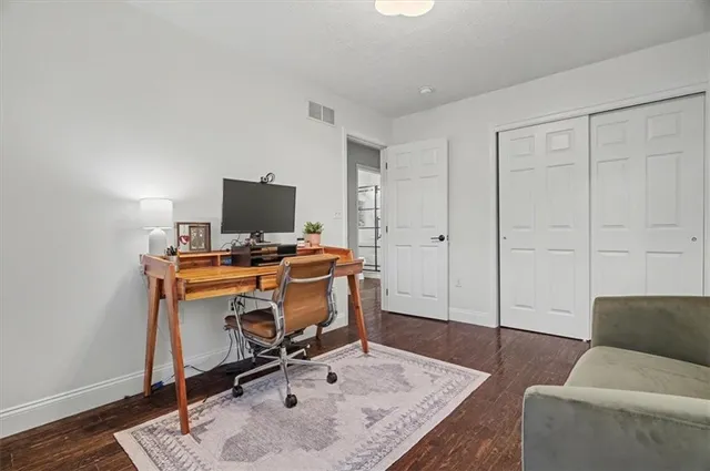 a livingroom with workspace and a couch