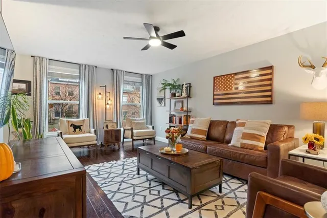 a living room with furniture and a large window