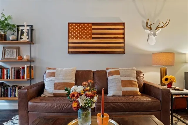 a living room with furniture and a book shelf