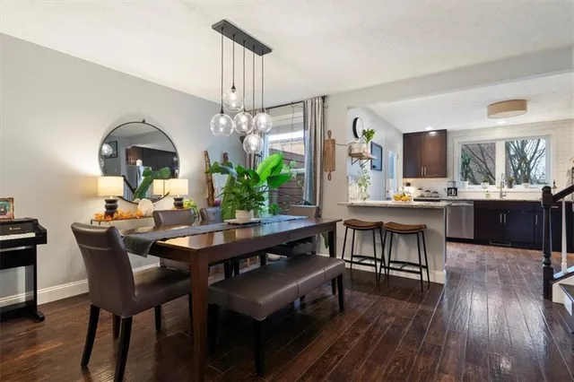 a dining room with a table chairs and a kitchen view