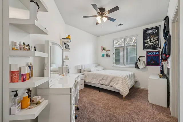 a spacious bedroom with a bed a couch and a window