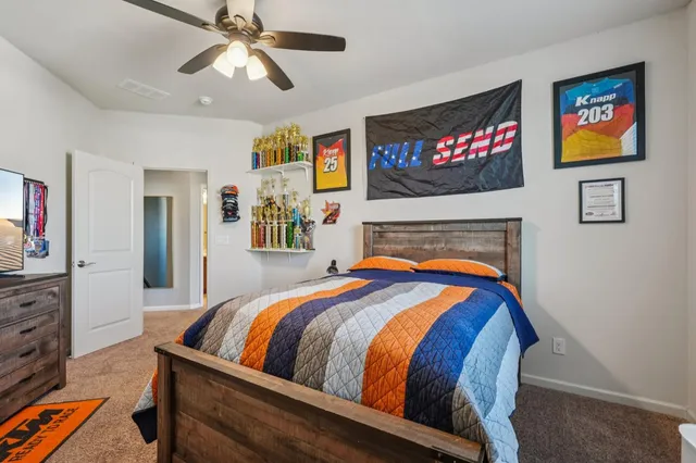 a bedroom with bed and a flat screen tv