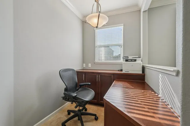 a view of a room with a window and furniture