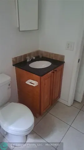 a bathroom with a sink toilet and mirror