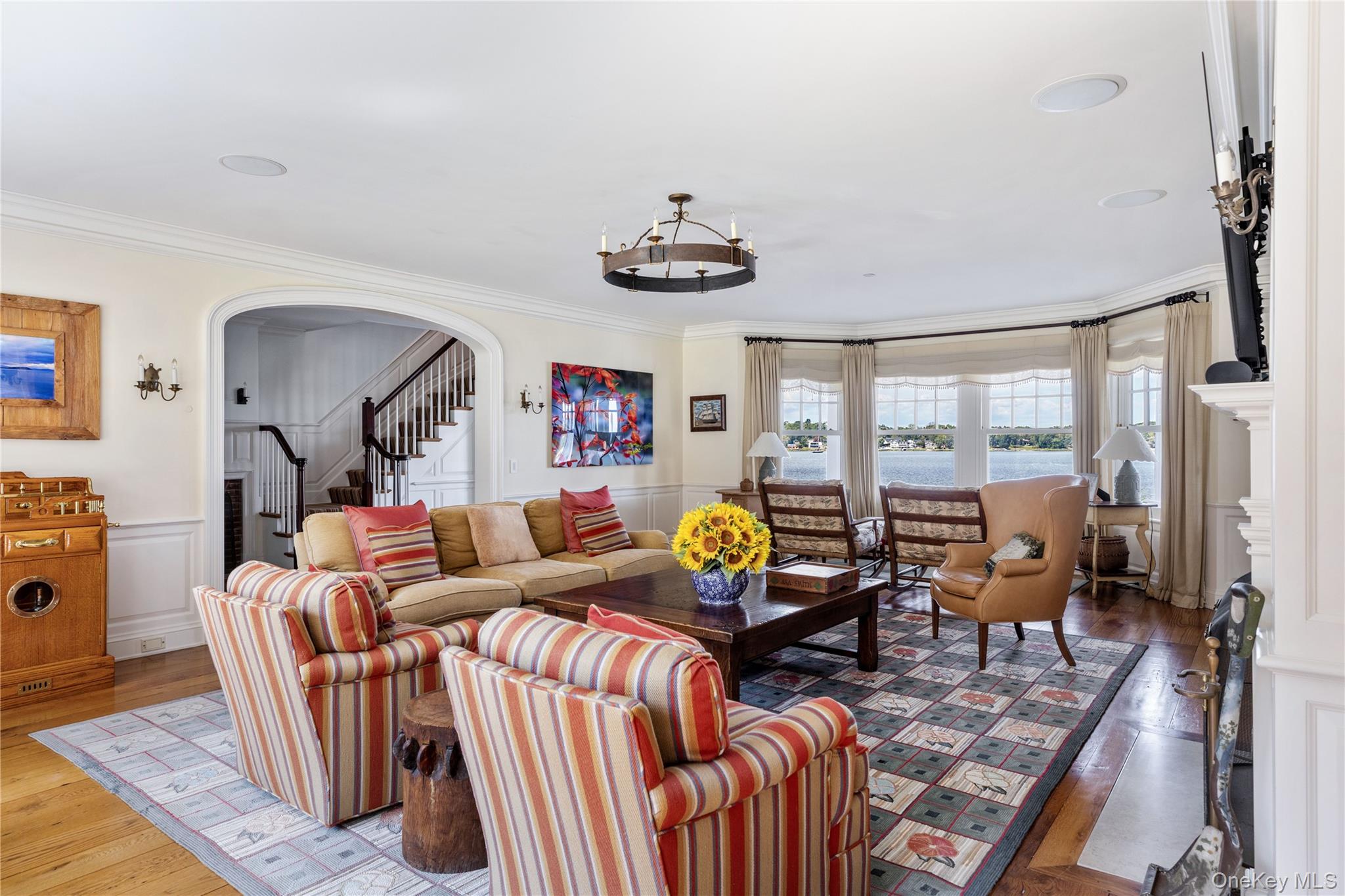 75 Cove Neck Road Cove Neck, NY 11771 - Photo 15 of 40 a living room with furniture a fireplace and large windows