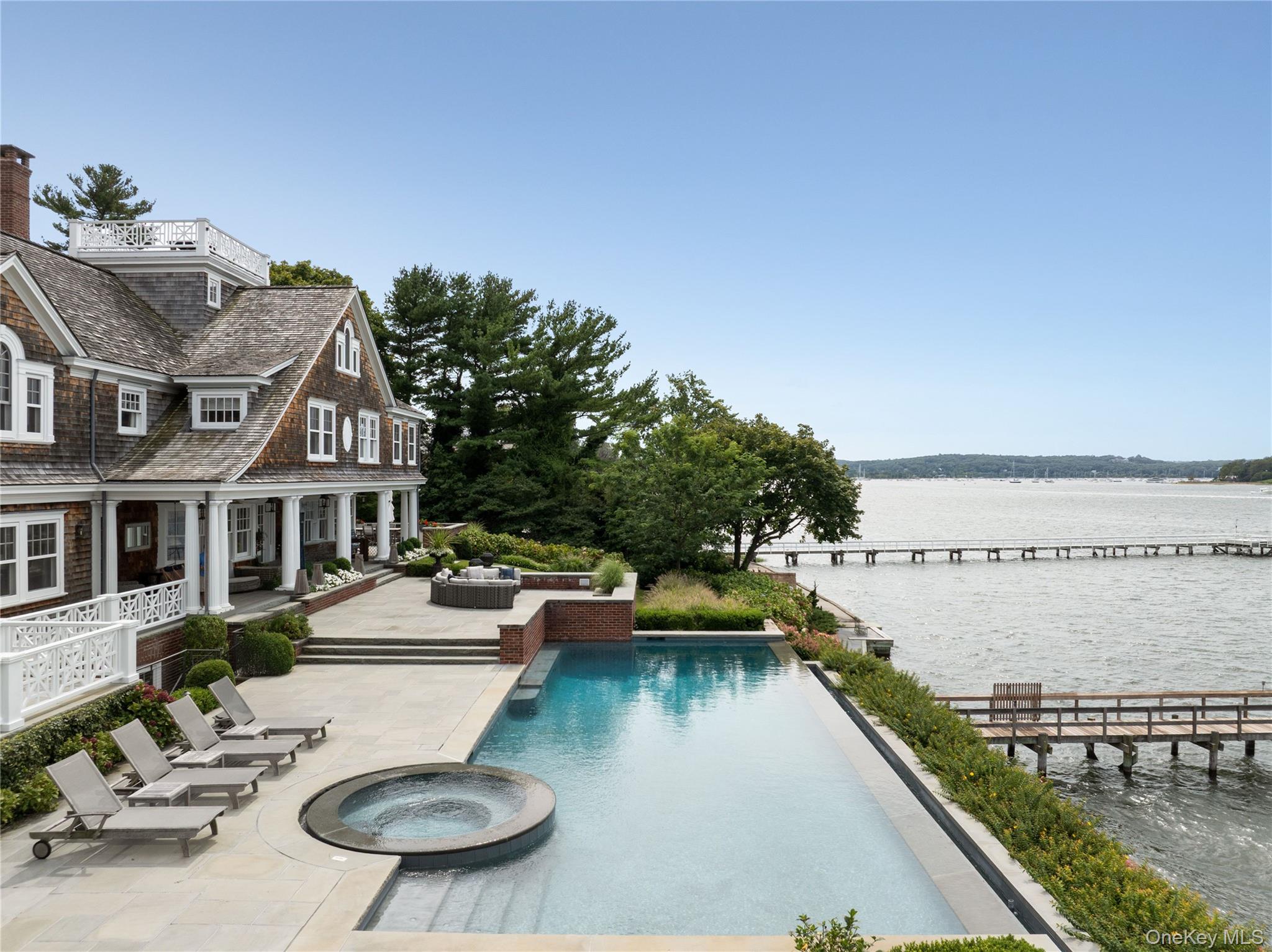 75 Cove Neck Road Cove Neck, NY 11771 - Photo 2 of 40 a view of a house with swimming pool and sitting area