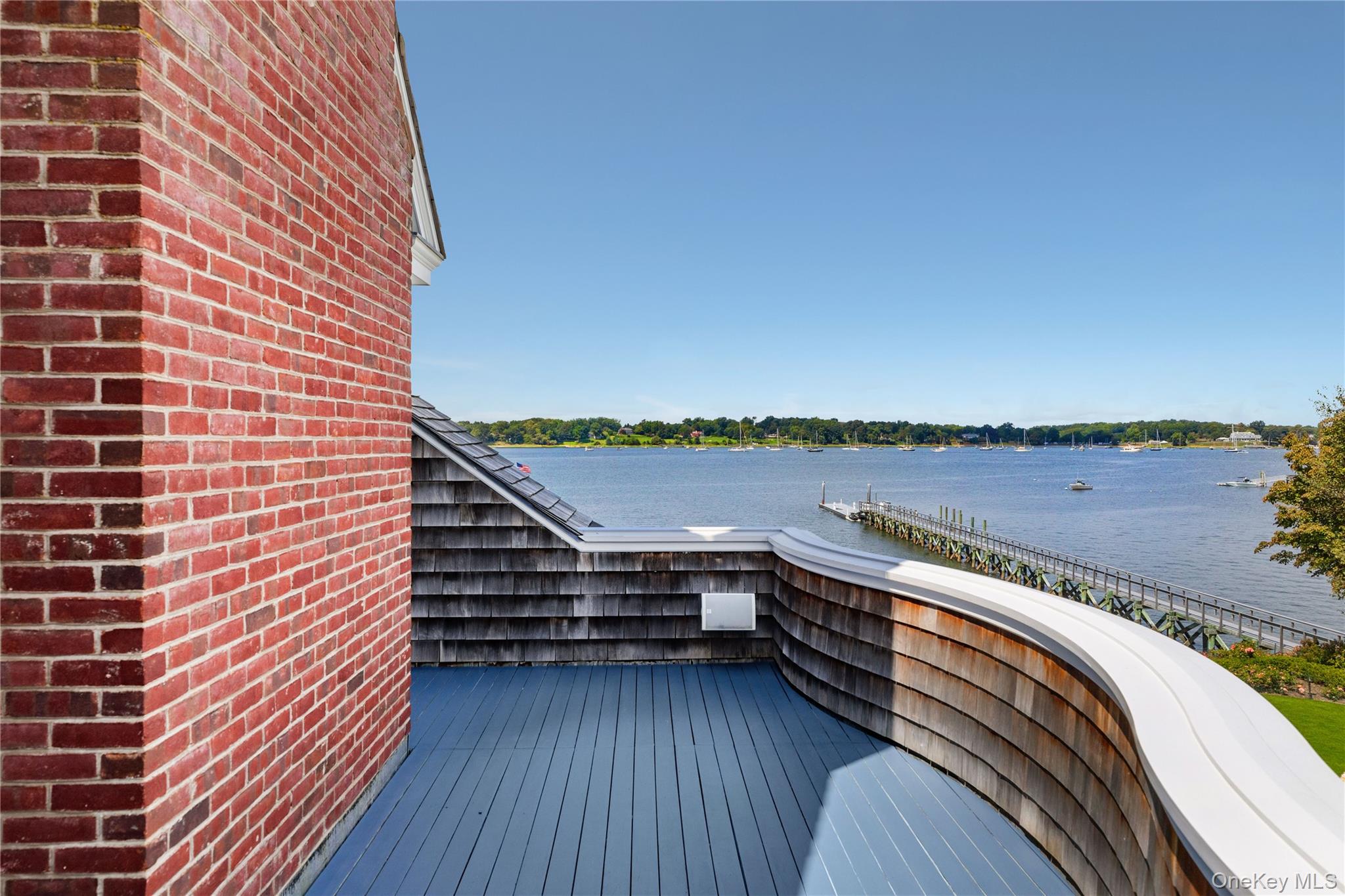 75 Cove Neck Road Cove Neck, NY 11771 - Photo 22 of 40 a view of balcony with ocean view and wooden floor
