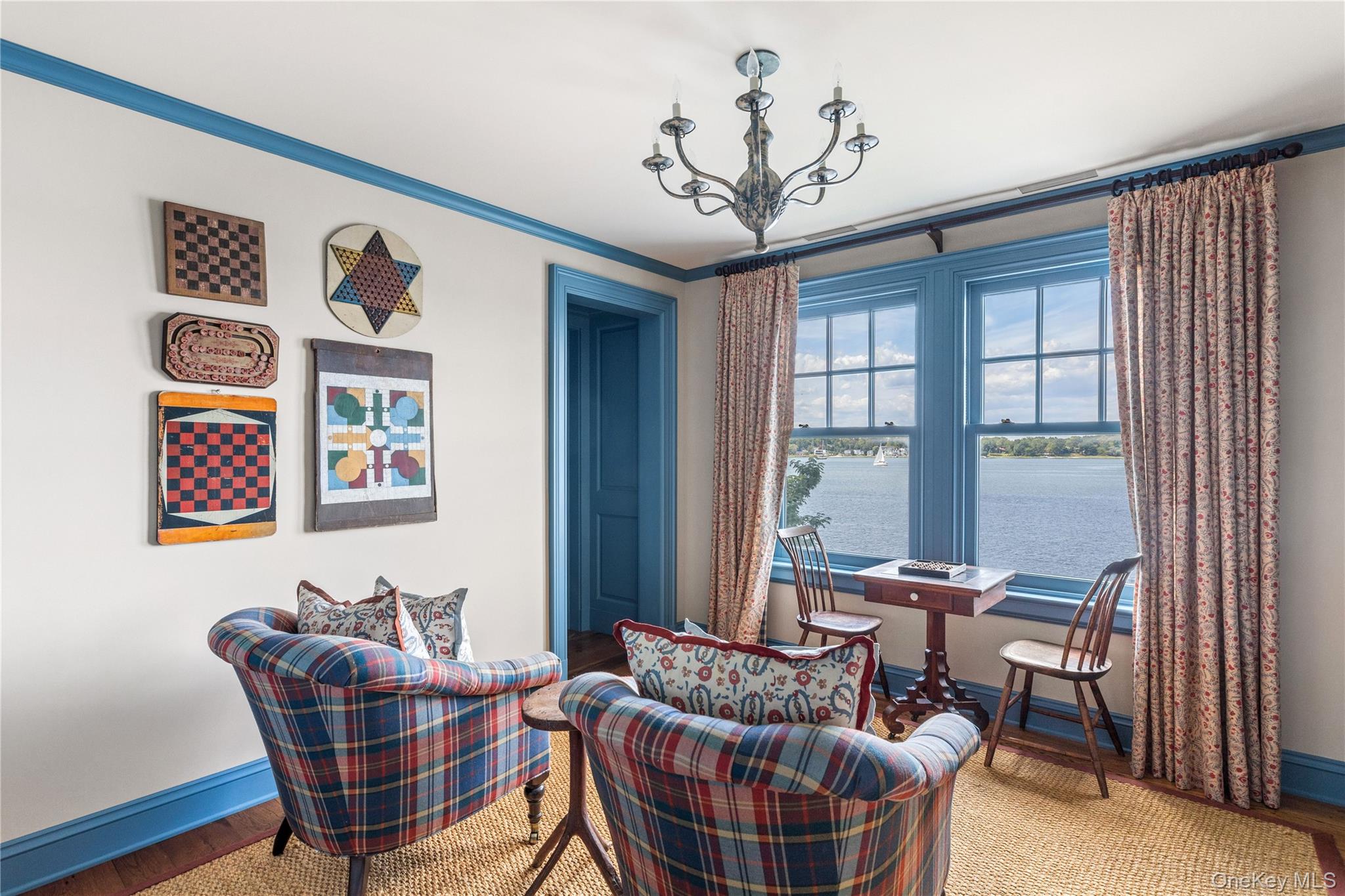 75 Cove Neck Road Cove Neck, NY 11771 - Photo 25 of 40 a living room with furniture a chandelier and a window