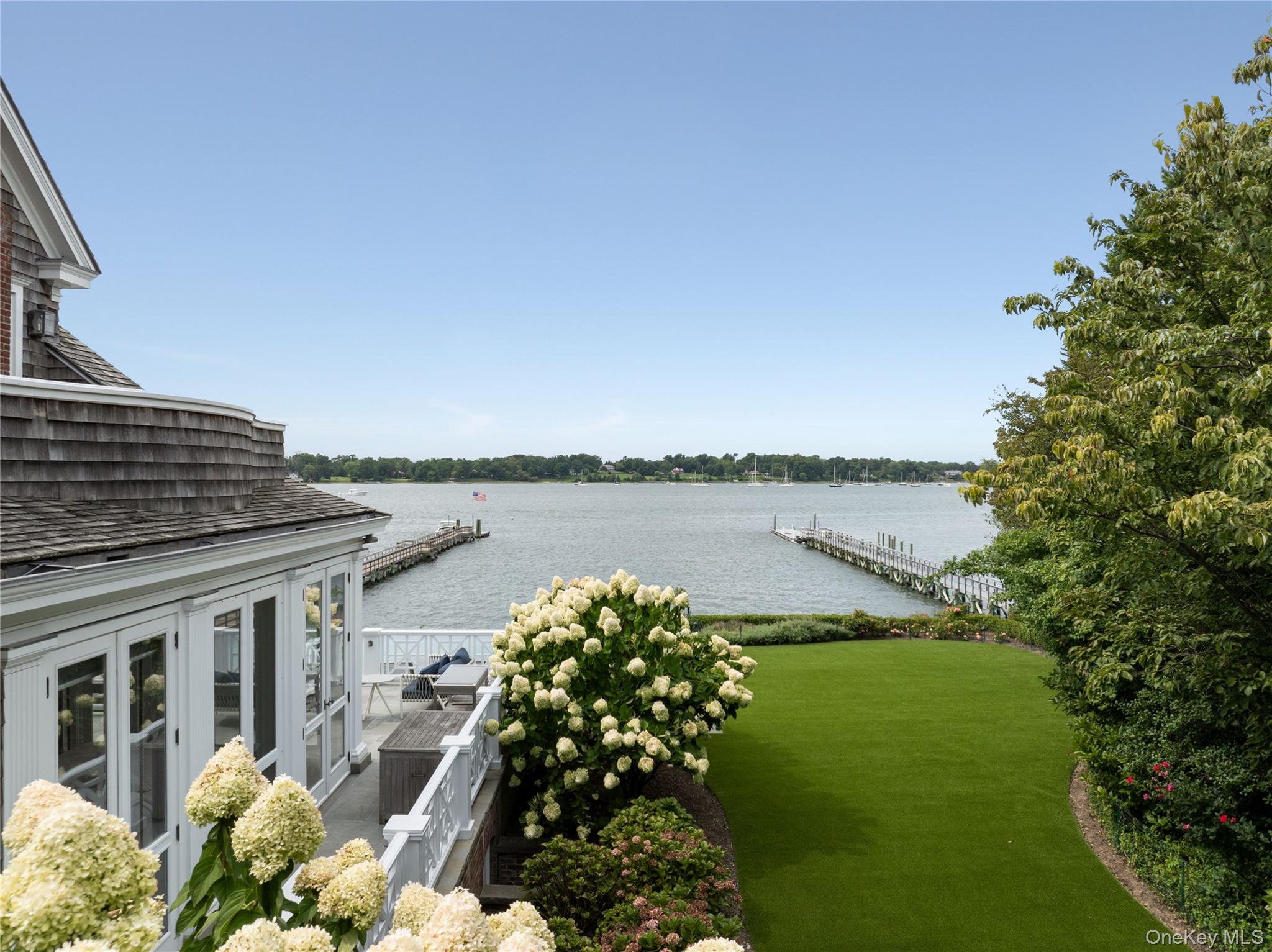 75 Cove Neck Road Cove Neck, NY 11771 - Photo 35 of 40 a view of a lake with a house in the background