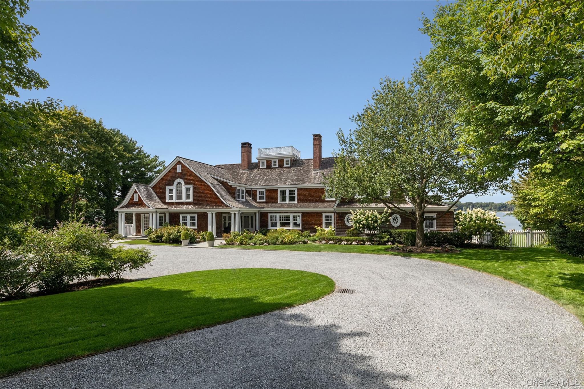 75 Cove Neck Road Cove Neck, NY 11771 - Photo 37 of 40 a front view of a house with a yard