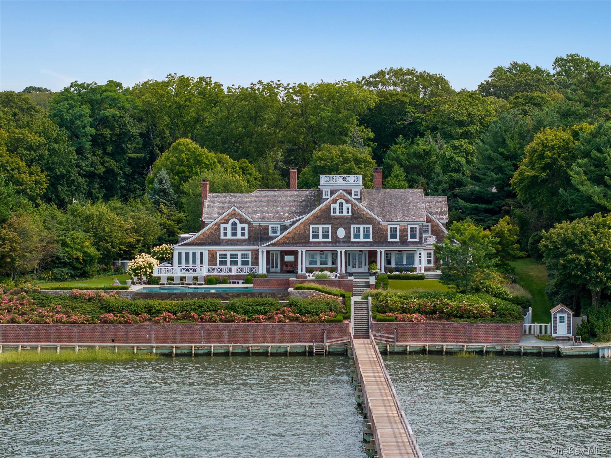 75 Cove Neck Road Cove Neck, NY 11771 - Photo 4 of 40 a front view of a house with a boat