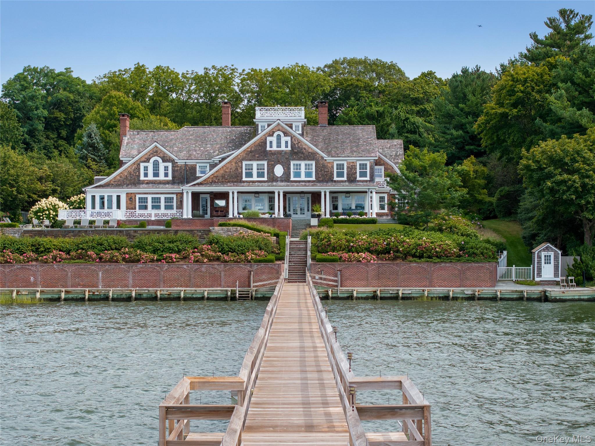 75 Cove Neck Road Cove Neck, NY 11771 - Photo 5 of 40 a front view of a house with a yard and potted plants
