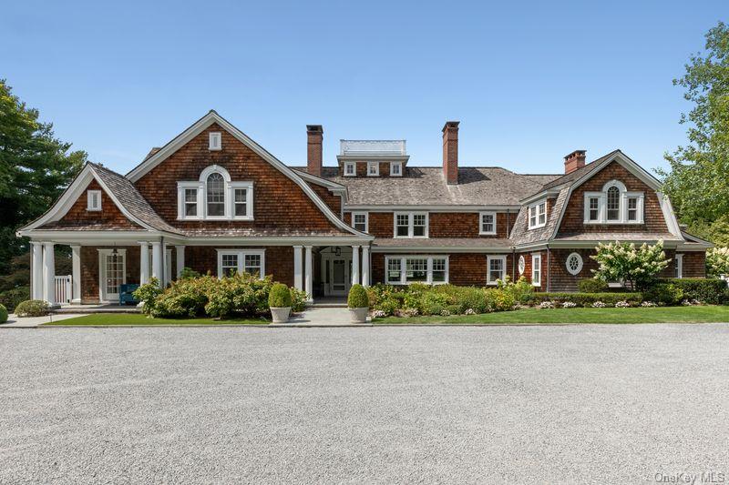 75 Cove Neck Road Cove Neck, NY 11771 - Photo 9 of 40 a front view of a house with a yard