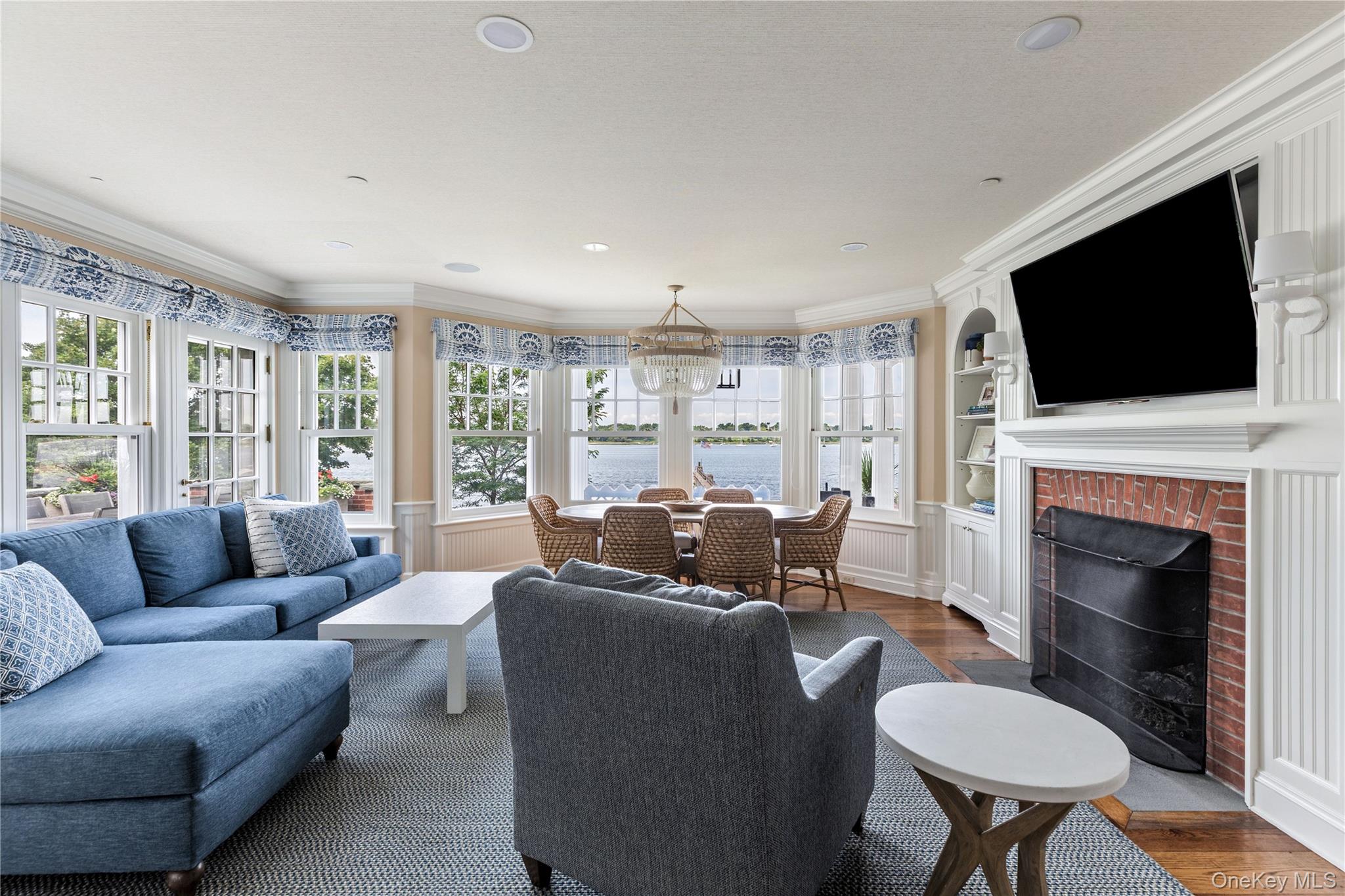 75 Cove Neck Road Cove Neck, NY 11771 - Photo 10 of 40 a living room with furniture a fireplace and a flat screen tv