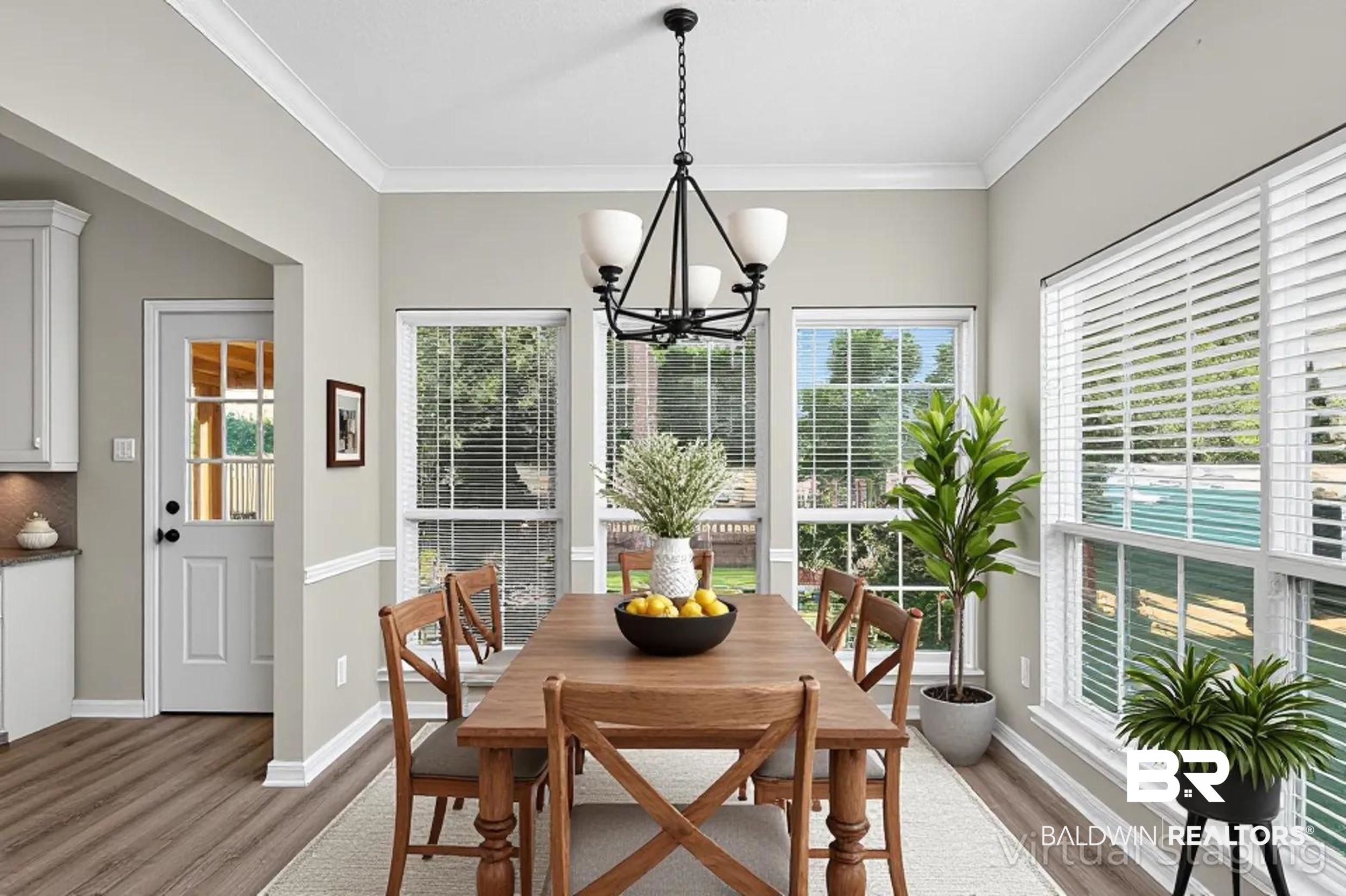 7050 Highpointe Place West Daphne, AL 36527 - Photo 18 of 66 Dining area with light wood-type flooring, a chandelier, ornamental molding, and healthy amount of natural light