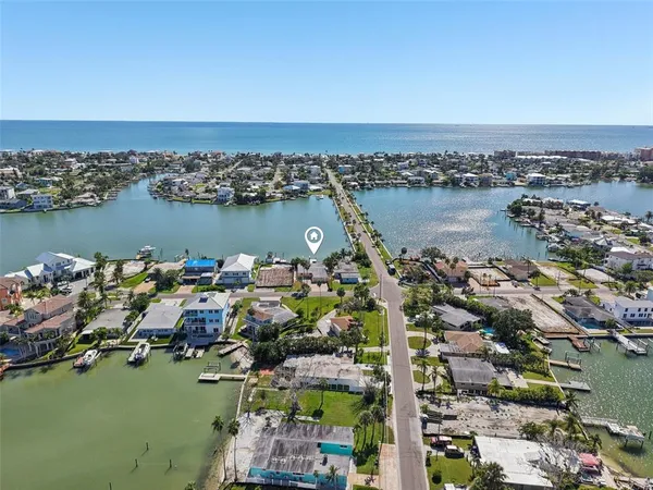 an aerial view of city and lake with boats