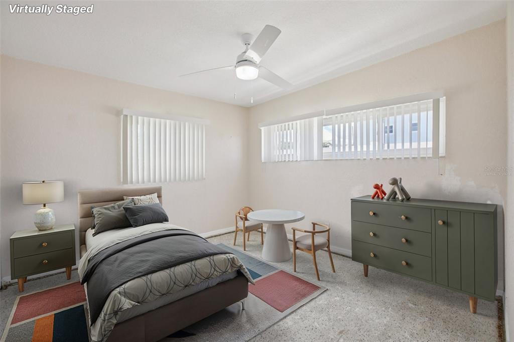 16016 4th Street East Redington Beach, FL 33708 - Photo 14 of 29 a bedroom with a bed and a chandelier