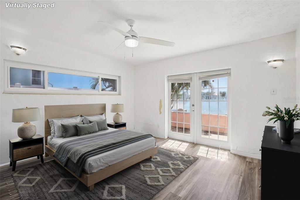 16016 4th Street East Redington Beach, FL 33708 - Photo 16 of 29 a bedroom with a large bed and wooden floor