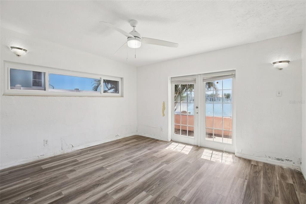 16016 4th Street East Redington Beach, FL 33708 - Photo 17 of 29 a view of an empty room with wooden floor and a window