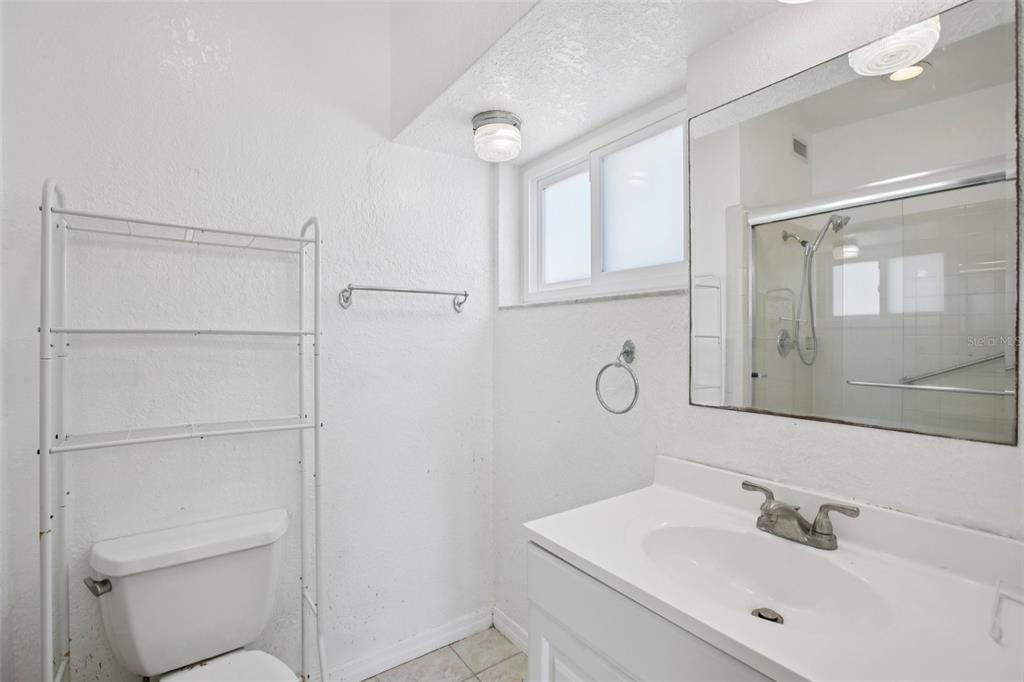 16016 4th Street East Redington Beach, FL 33708 - Photo 19 of 29 a bathroom with a sink a toilet and shower