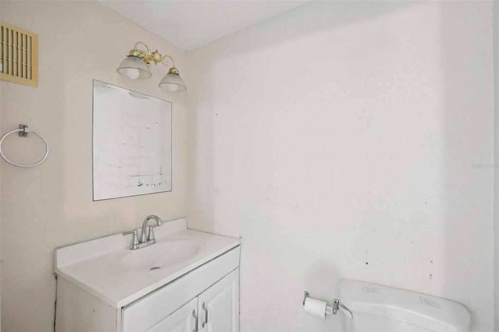16016 4th Street East Redington Beach, FL 33708 - Photo 23 of 29 a bathroom with a sink vanity and a mirror