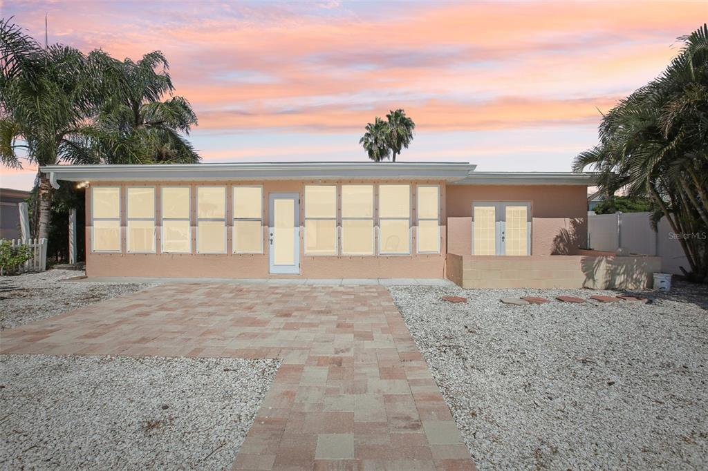 16016 4th Street East Redington Beach, FL 33708 - Photo 28 of 29 a view of an house with backyard and trees
