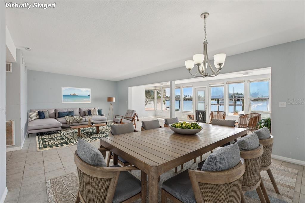 16016 4th Street East Redington Beach, FL 33708 - Photo 3 of 29 a view of a dining room with furniture wooden floor and chandelier
