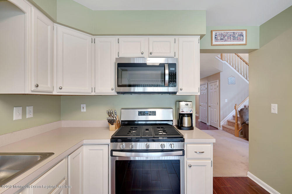 8 Bristel Road Holmdel, NJ 07733 - Photo 14 of 30 a kitchen with granite countertop white cabinets and stainless steel appliances