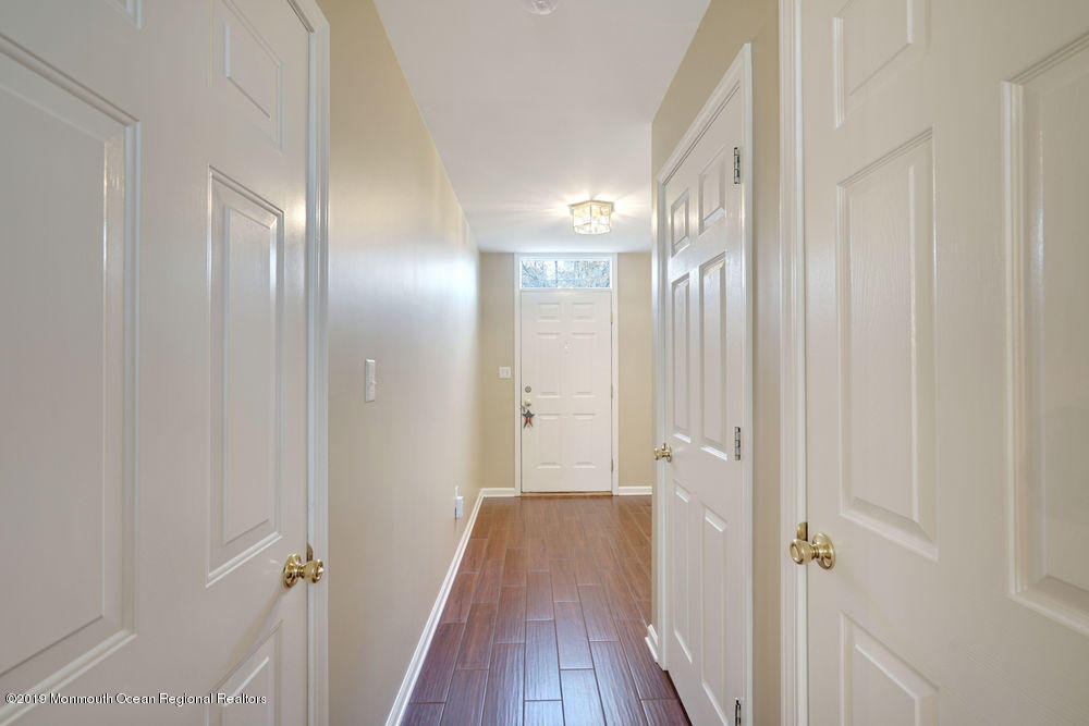 8 Bristel Road Holmdel, NJ 07733 - Photo 3 of 30 a view of a hallway with wooden floor and closet area