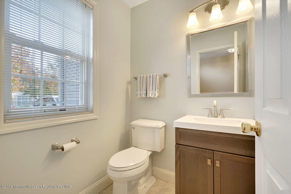 8 Bristel Road Holmdel, NJ 07733 - Photo 4 of 30 a bathroom with a toilet sink and mirror