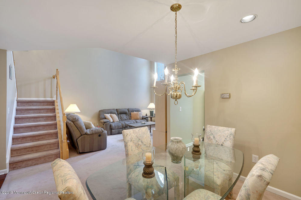 8 Bristel Road Holmdel, NJ 07733 - Photo 7 of 30 a living room with furniture a dining table and a chandelier