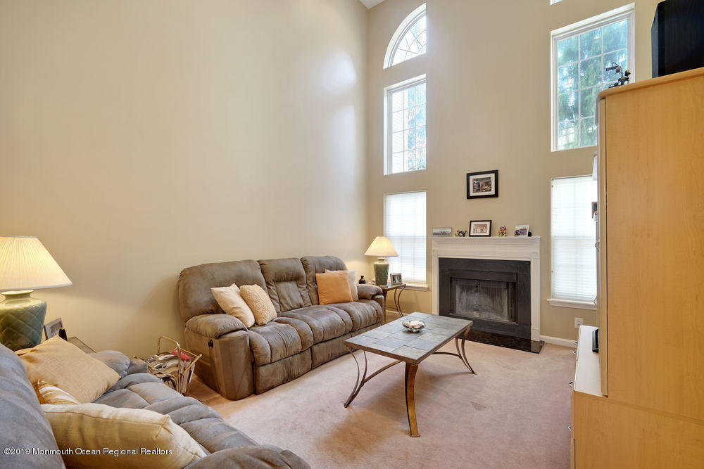 8 Bristel Road Holmdel, NJ 07733 - Photo 9 of 30 a living room with furniture and a fireplace