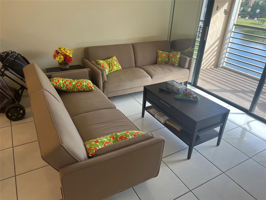 10100 Northwest 30th Court, Unit 310 Sunrise, FL 33322 - Photo 17 of 60 a living room with furniture and wooden floor