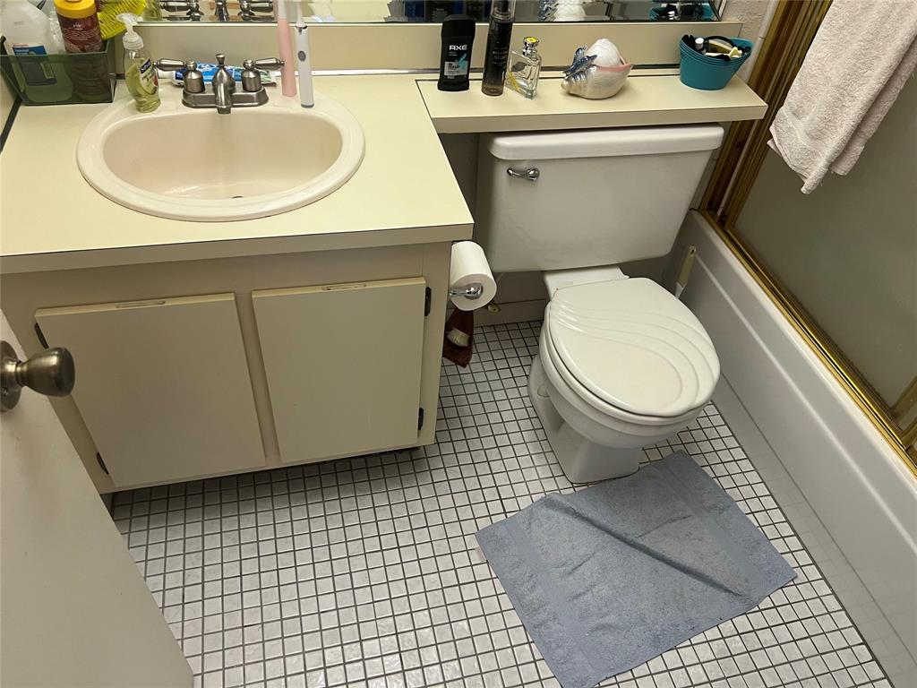 10100 Northwest 30th Court, Unit 310 Sunrise, FL 33322 - Photo 30 of 60 a white toilet sitting next to a bathroom sink