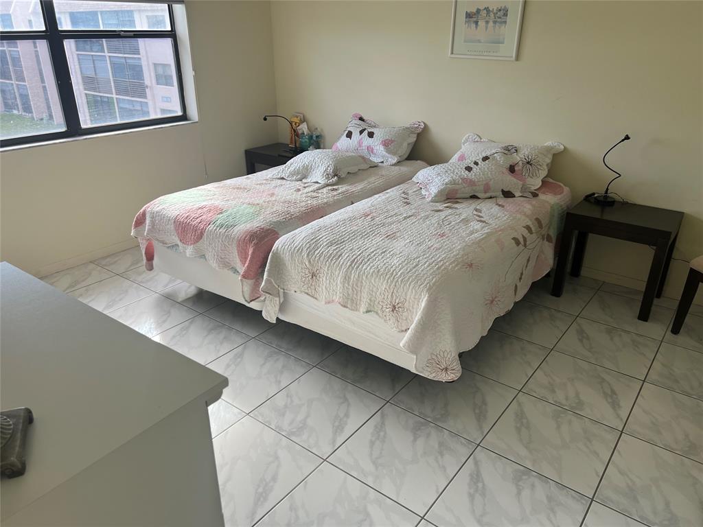 10100 Northwest 30th Court, Unit 310 Sunrise, FL 33322 - Photo 31 of 60 a bedroom with a bed and a window