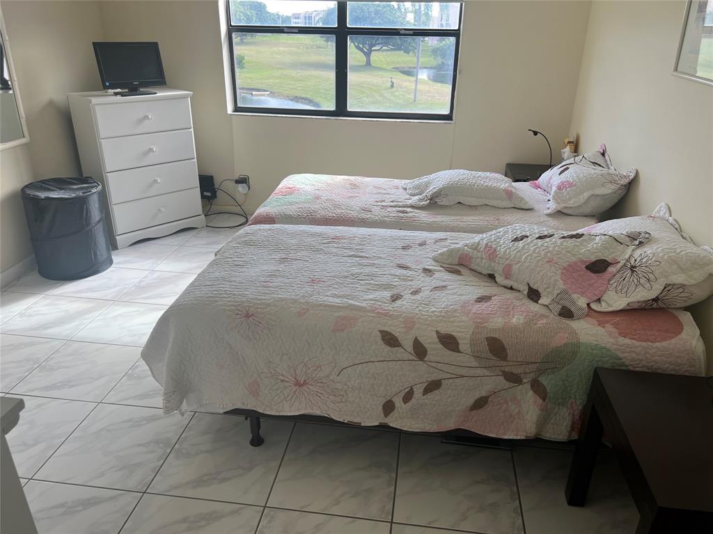 10100 Northwest 30th Court, Unit 310 Sunrise, FL 33322 - Photo 32 of 60 a bedroom with a bed and a window