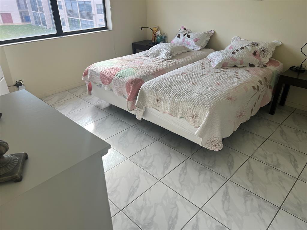 10100 Northwest 30th Court, Unit 310 Sunrise, FL 33322 - Photo 33 of 60 a bedroom with a bed and a window