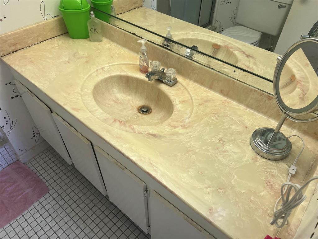 10100 Northwest 30th Court, Unit 310 Sunrise, FL 33322 - Photo 35 of 60 a bathroom with a sink and a mirror