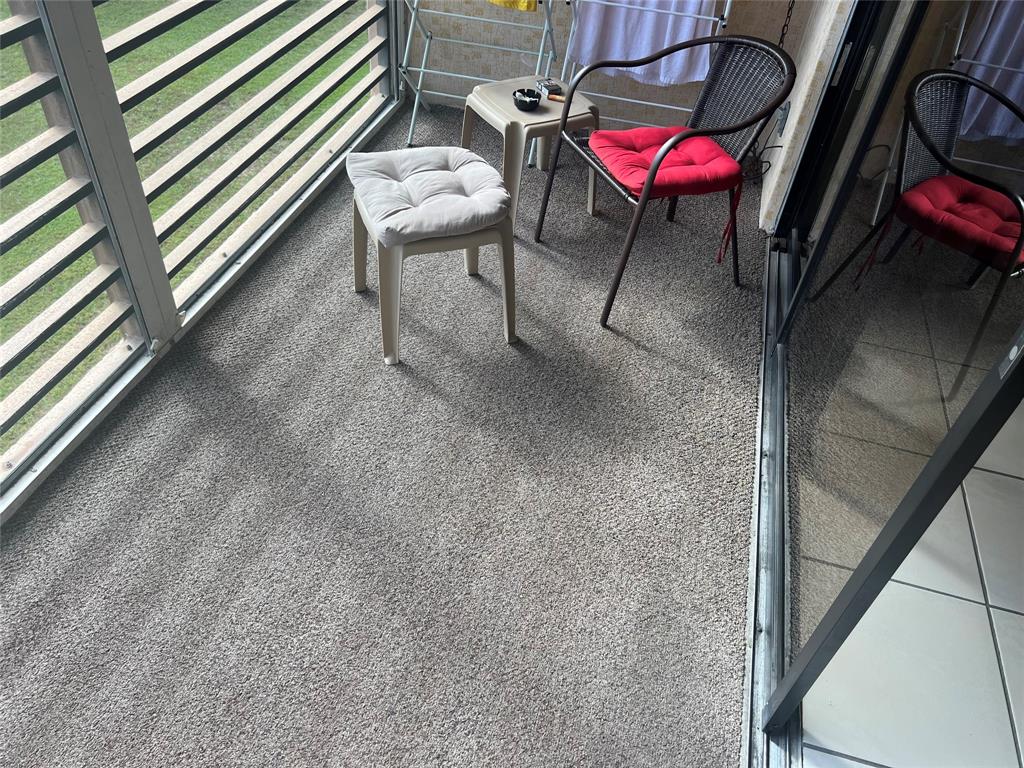 10100 Northwest 30th Court, Unit 310 Sunrise, FL 33322 - Photo 41 of 60 a view of a chairs and table in the balcony