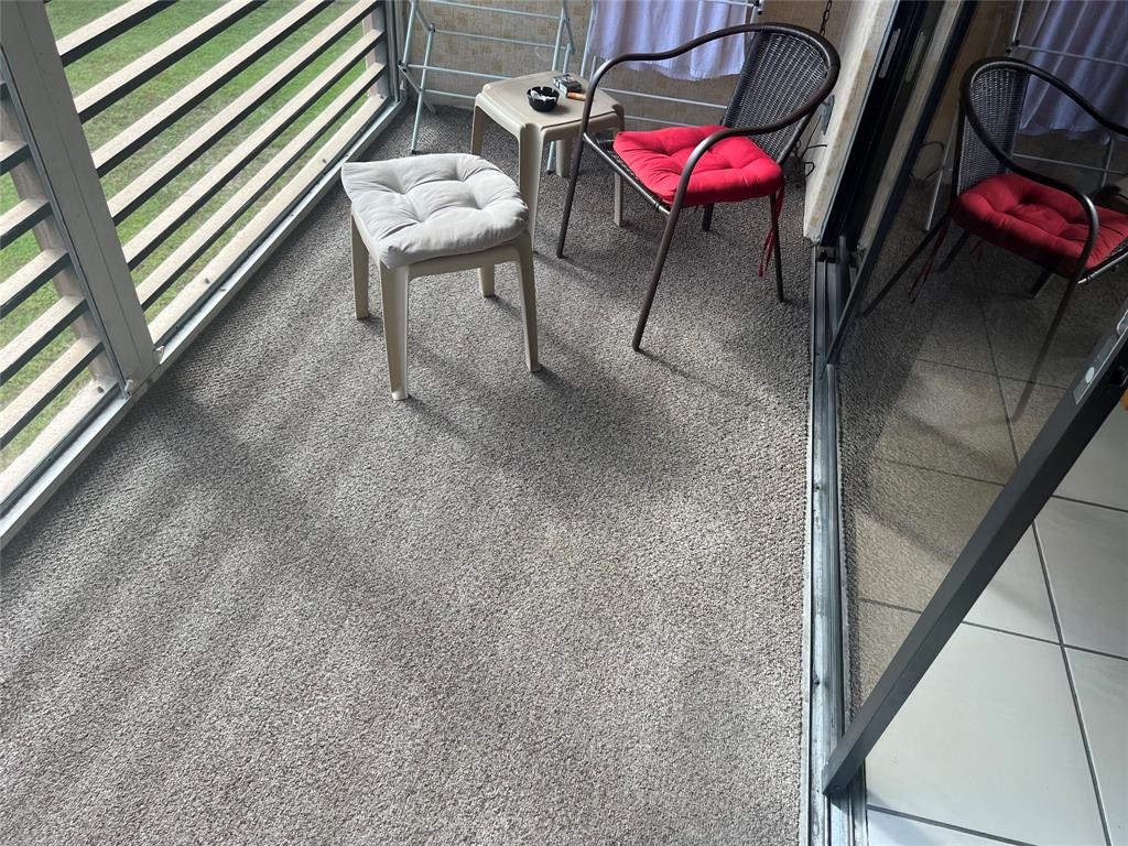 10100 Northwest 30th Court, Unit 310 Sunrise, FL 33322 - Photo 42 of 60 a view of a chairs and table in the balcony