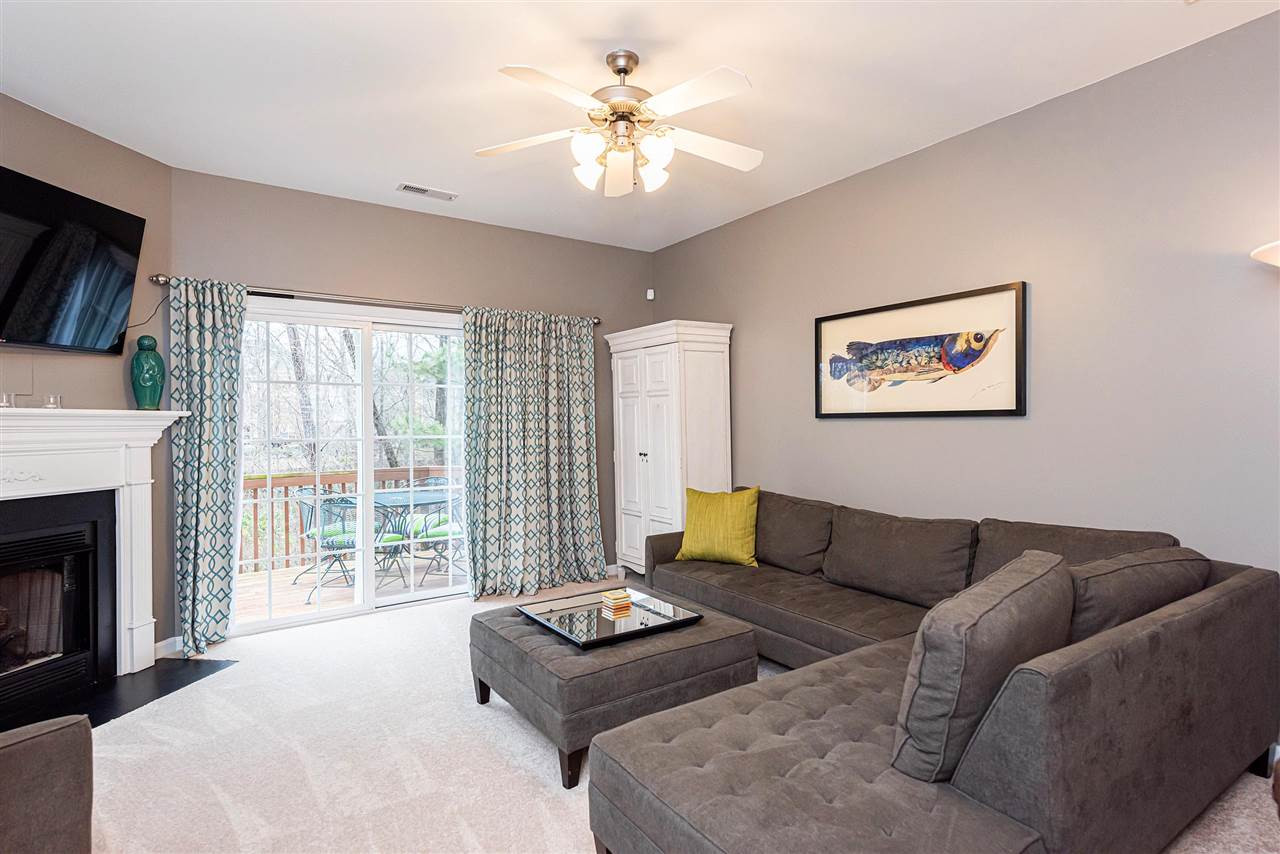 7749 Winners Edge Street Raleigh, NC 27617 - Photo 6 of 29 Family Room features gas log fireplace and sliding door access to back deck. Family Room